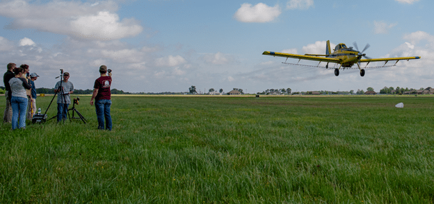 Students conduct an Operation S.A.F.E. clinic as another student flies the AT-802.